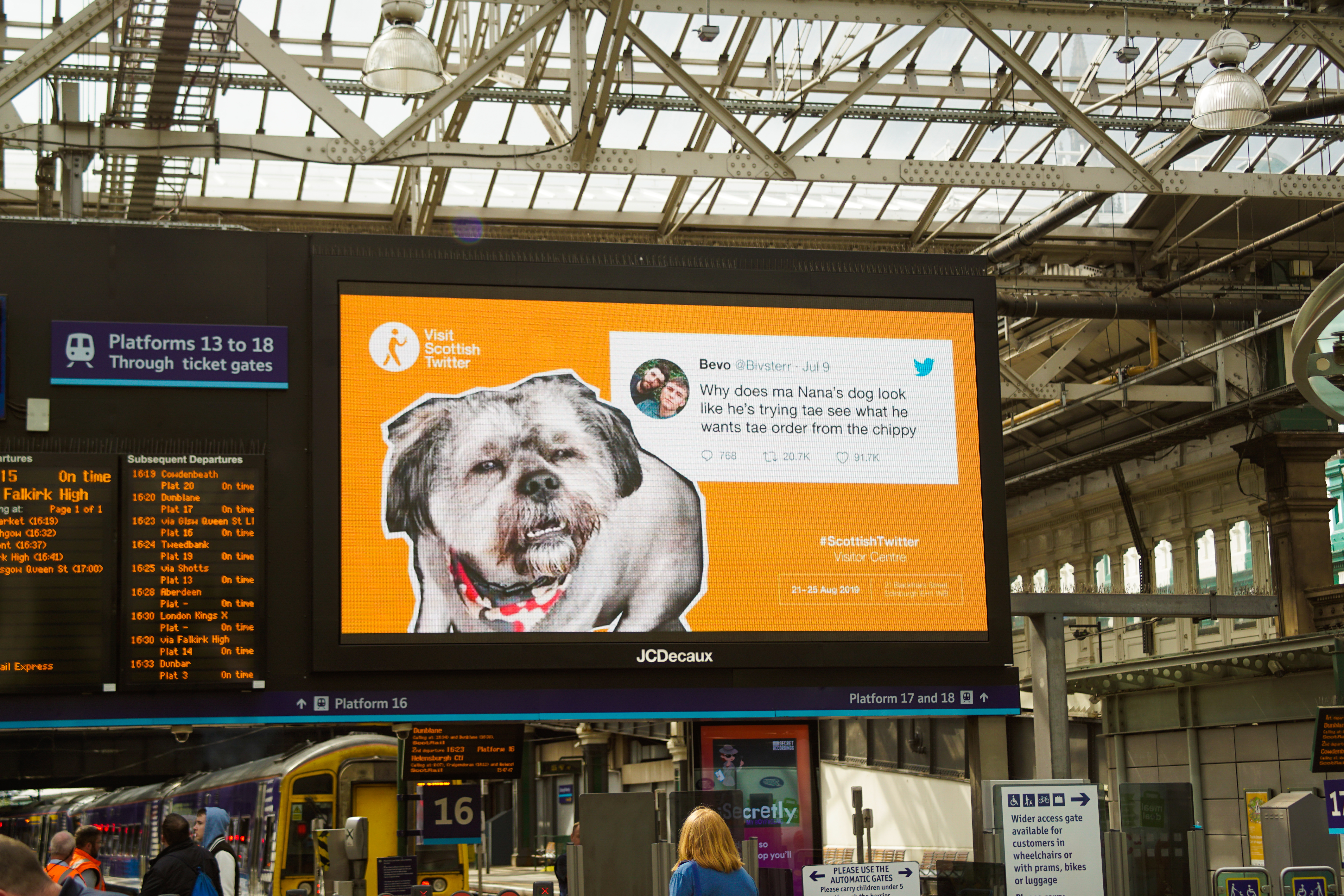 A photograph of a billboard featuring a Scottish Tweet and accompanying imagery