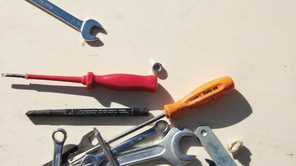 work tools (wrench, spanner, screwdriver) on plain background